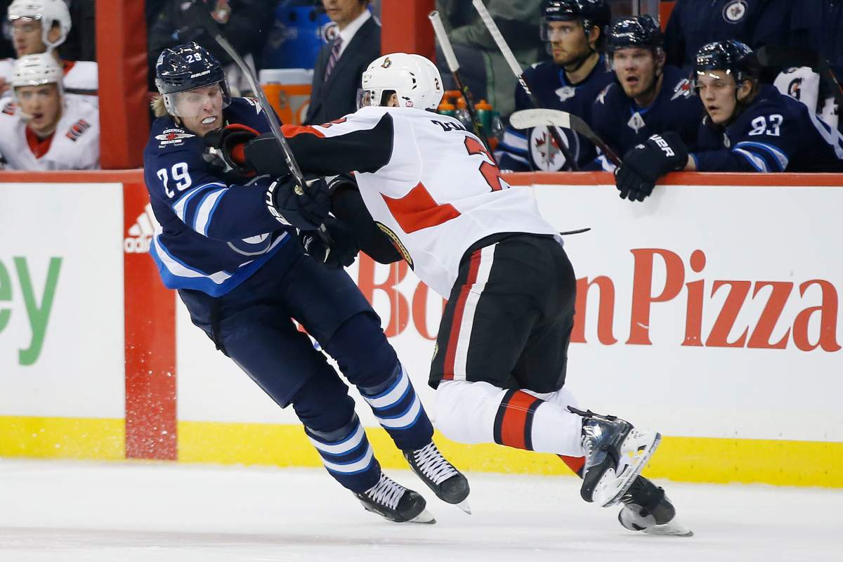 Winnipeg Jets' Patrik Laine (29) can't get past Ottawa Senators' Dylan DeMelo (2) during second period NHL action in Winnipeg on Saturday, Feb. 16, 2019.