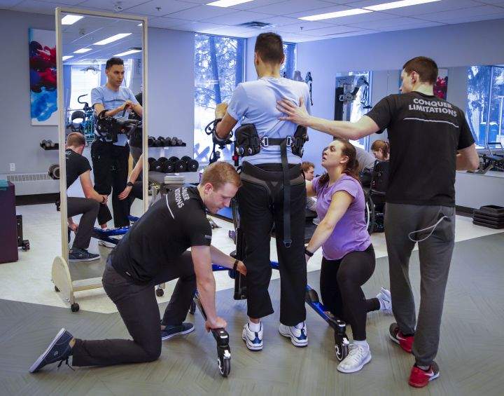 Dr. Richi Gill, in grey shirt, a Calgary doctor, takes part in physiotherapy in Calgary, Alta., Wednesday, Feb. 13,