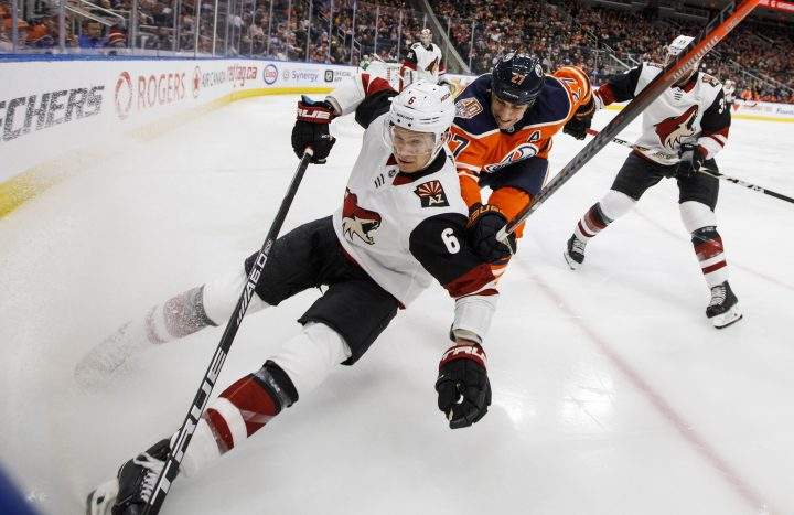 Arizona Coyotes’ Jakob Chychrun (6) and Edmonton Oilers’ Milan Lucic (27) battle for the puck during second period NHL action in Edmonton, Alta., on Tuesday, Feb. 19, 2019.
