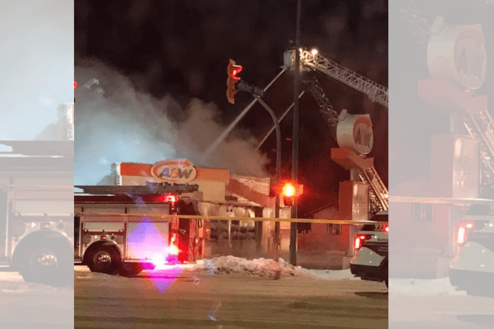 Crews are seen working to put out flames at A&W restaurant.