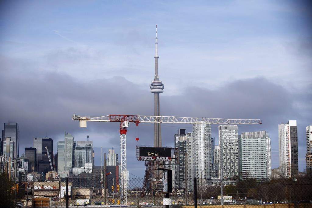 Condominiums and the CN Tower are shown along the Toronto skyline. THE CANADIAN PRESS/Cole Burston