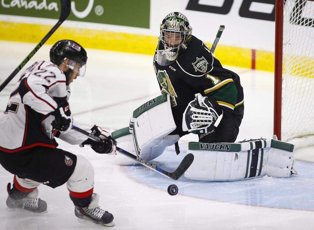 The Rouyn-Noranda Huskies' Peter Abbandonato, left, shoots on London Knights goalie Tyler Parsons during first-period CHL Memorial Cup hockey action in Red Deer, Alta., Tuesday, May 24, 2016.