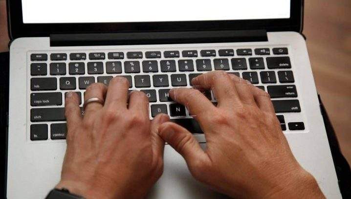 A person works on a laptop.