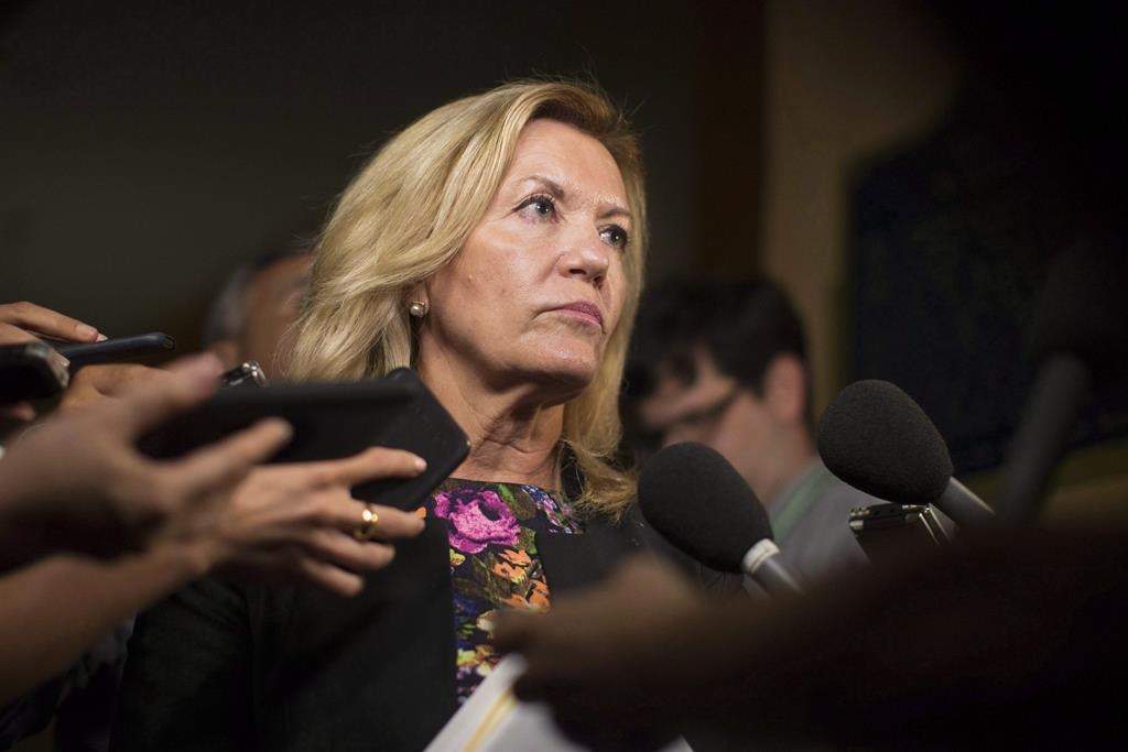 Ontario Deputy Premier Christine Elliott talks with journalists following Question Period at the Ontario Legislature in Toronto on Wednesday, August 1, 2018.