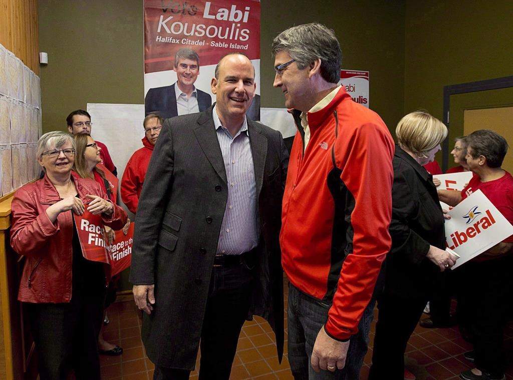 Nova Scotia Liberal Leader Stephen McNeil, right, chats with Labi Kousoulis, in Halifax on Monday, Oct. 7, 2013. Kousoulis, Nova Scotia's labour minister, says the threat of closure is his best tool to penalize a coal mine that broke mining rules by not reporting two massive cave-ins within the required 24 hours.