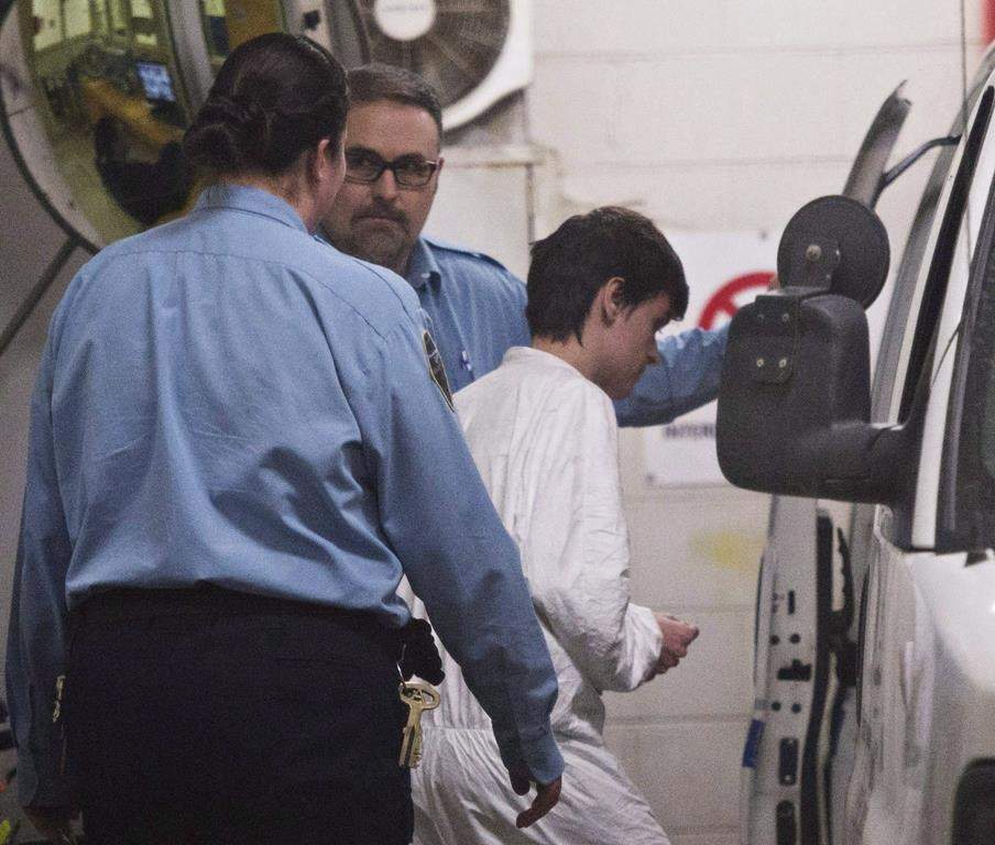 Alexandre Bissonnette is escorted to a van after appearing in court for the deadly shooting at a mosque on January 30, 2017 in Quebec City.