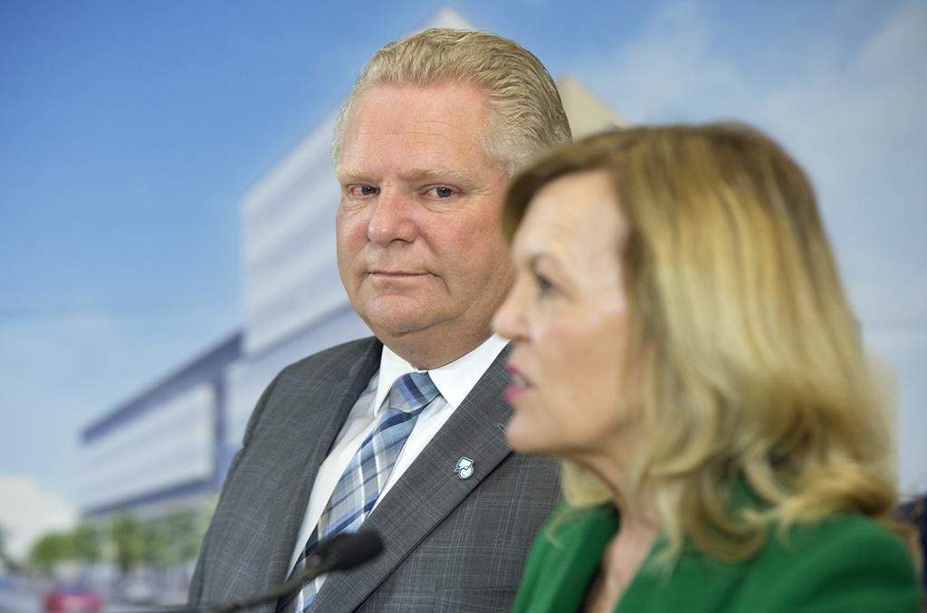 Ontario Premier Doug Ford watches as Health Minister Christine Elliott speaks at an event at the Centre for Addiction and Mental Health in Toronto on Jan. 30, 2019.