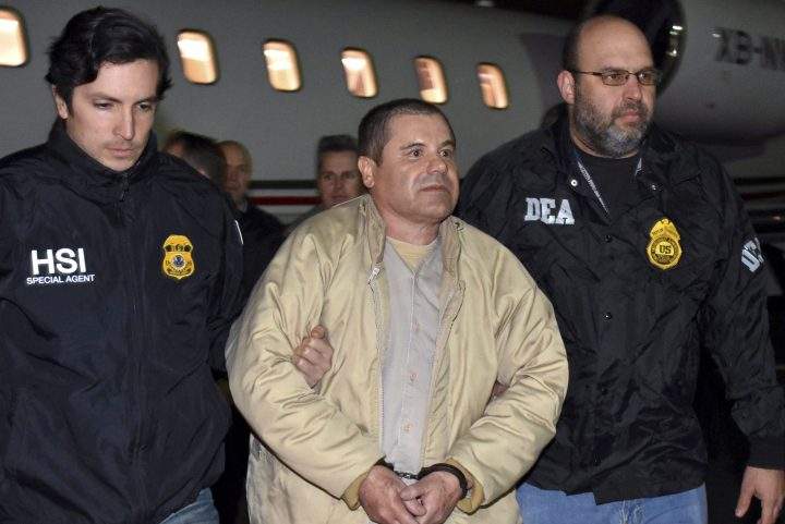 In this Jan. 19, 2017 file photo, authorities escort Joaquin “El Chapo” Guzman, centre, from a plane to a waiting caravan of SUVs at Long Island MacArthur Airport, in Ronkonkoma, N.Y.