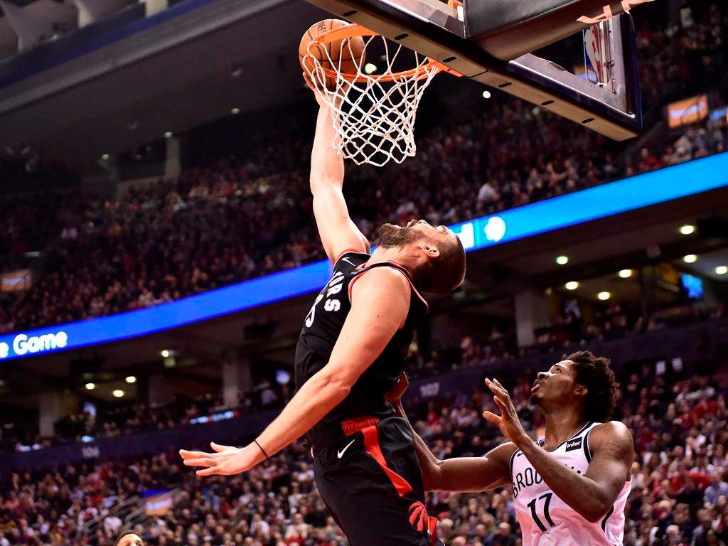 Toronto Raptors Marc Gasol makes a reverse dunk as Brooklyn Nets forward Ed Davis (17) looks on during second half NBA basketball action in Toronto on Monday, Feb. 11, 2019. THE CANADIAN PRESS/Frank Gunn