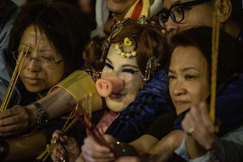 Hong Kong actress Lana Wong (C) is dressed in Pig costume as she gathers with worshippers at the Wong Tai Sin Temple to welcome in the Lunar New Year of the Pig in Hong Kong late on February 4, 2019. Worshippers flocked to temples to pray for good luck and fortune for the new year. (Photo by Philip FONG / AFP) (Photo credit should read PHILIP FONG/AFP/Getty Images)