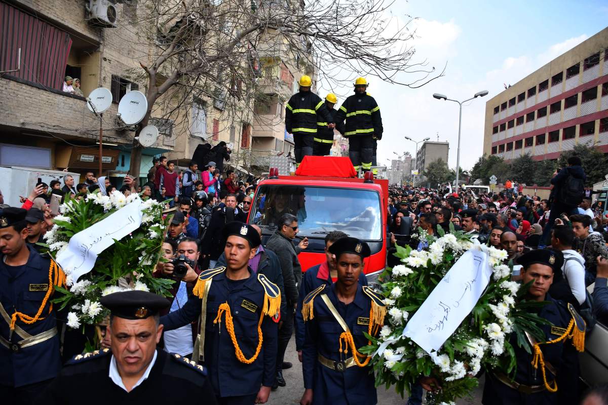 Egyptian policemen carry wreaths as they attend the funeral of policeman Mahmud Abu el-Yzied, one of three policemen killed in a bombing a day earlier, in the Embaba district of the capital Cairo, on February 19, 2019.