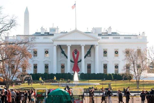 A red ribbon in recognition of World AIDS Day hangs from the North Portico of the White House in Washington, D.C, Dec. 1, 2017.