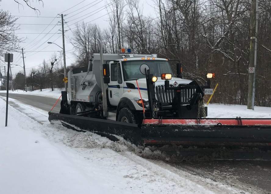 Guelph police say a pole fell on a transit bus after it was clipped by a street plow.