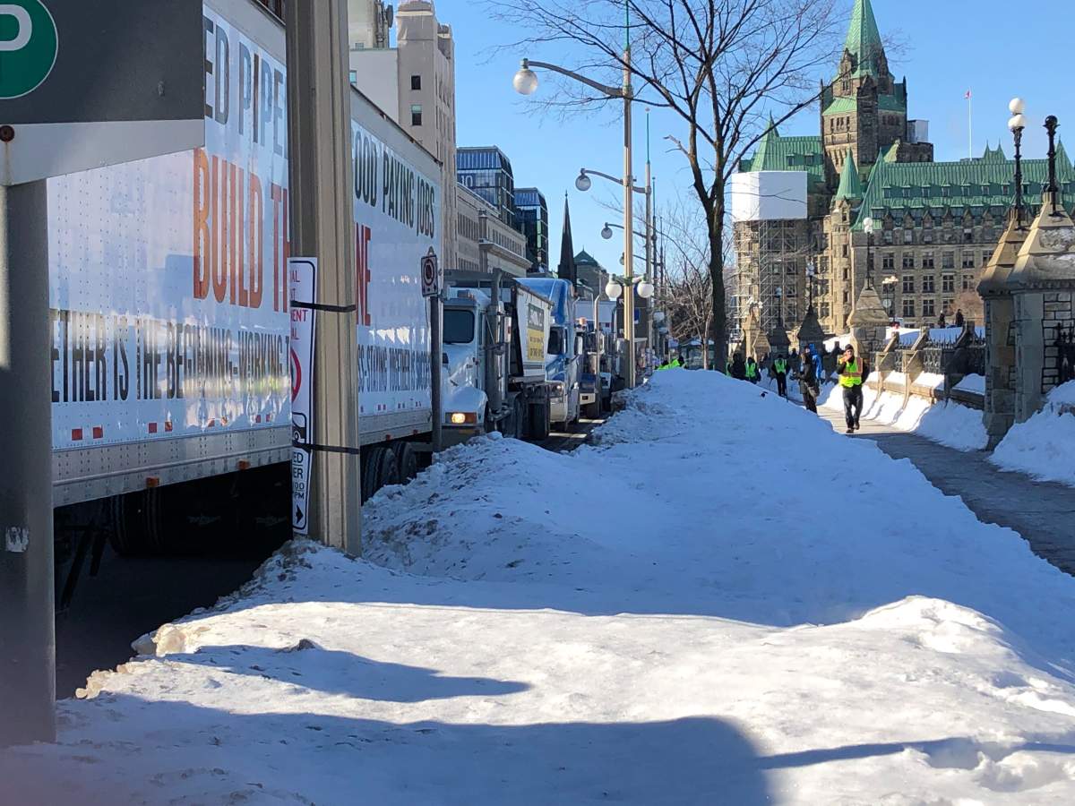 A convoy of trucks which began in Western Canada are lined up along Wellington Street in Ottawa on Tuesday.