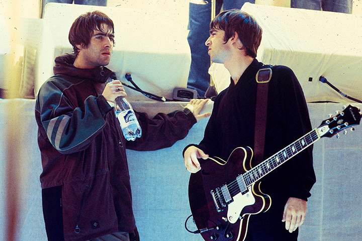 (L-R) Brothers Liam and Noel Gallagher of Oasis talking on the set of a U.K. TV show. (File photo).