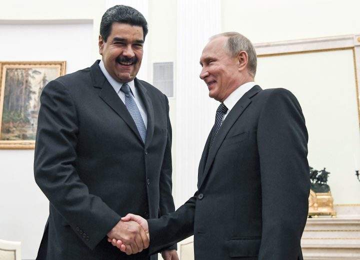 In this file pool photo taken on Oct. 4, 2017, Russian President Vladimir Putin, right, shakes hands with Venezuela’s President Nicolas Maduro during their meeting at the Kremlin in Moscow, Russia.