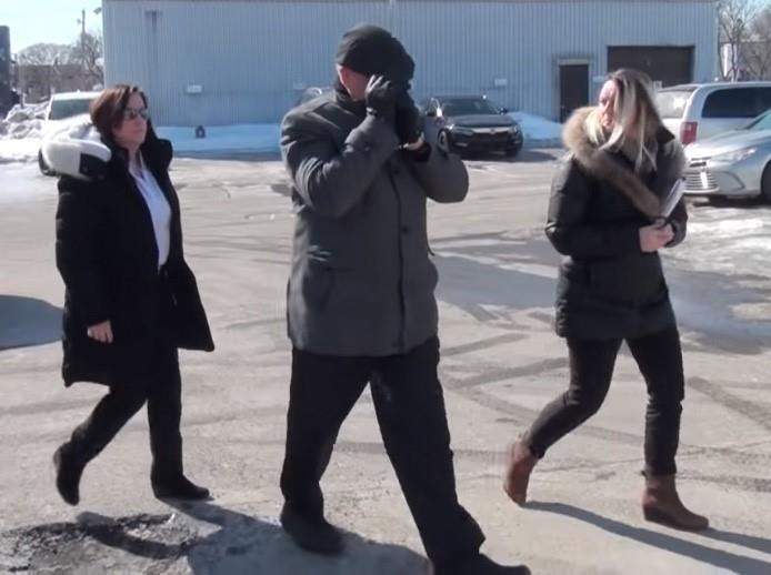 In this image taken from video, police take Mario Monette into custody in Longueuil, Que.