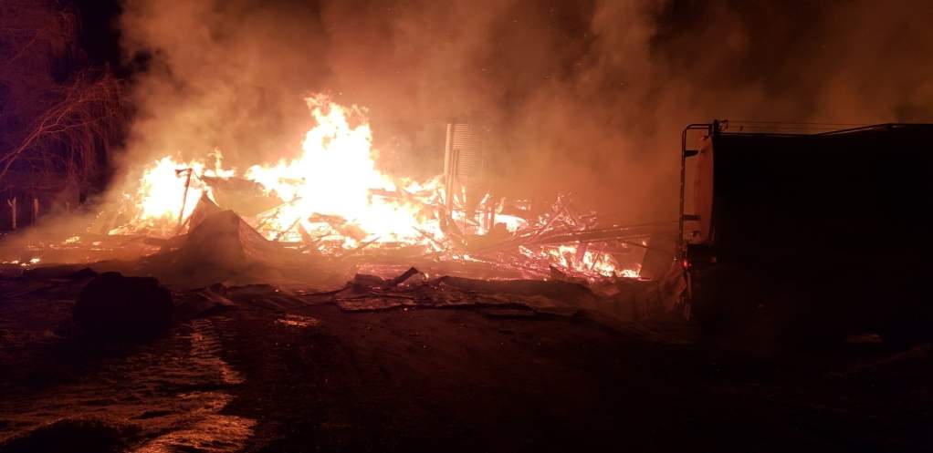 Napanee Fire Department work on extinguishing a fire at a barn on County Road 2.