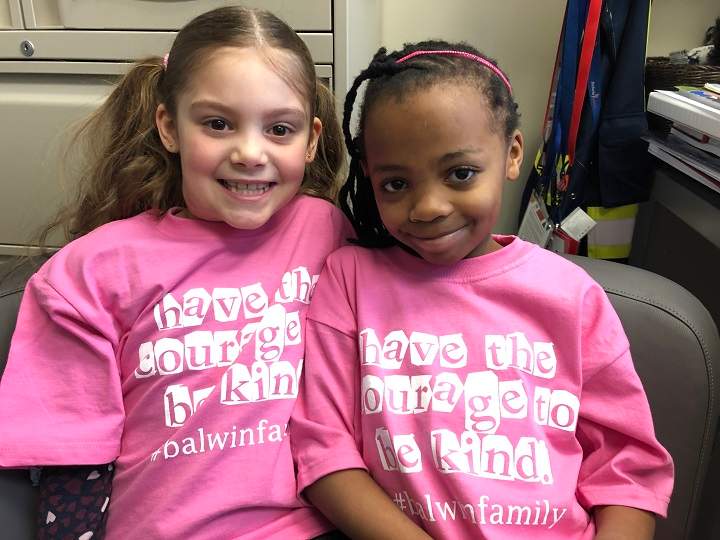 Grade 2 students at Balwin School, Naomi Kisabo and Mary-Lynn McInnes pose together on Pink Shirt Day