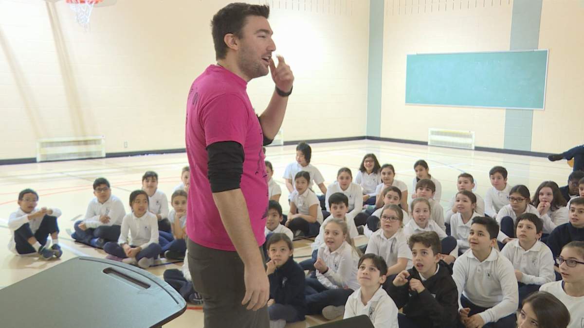 Travis Price speaks to students at General Vanier Elementary School about bullying.  (Global News).