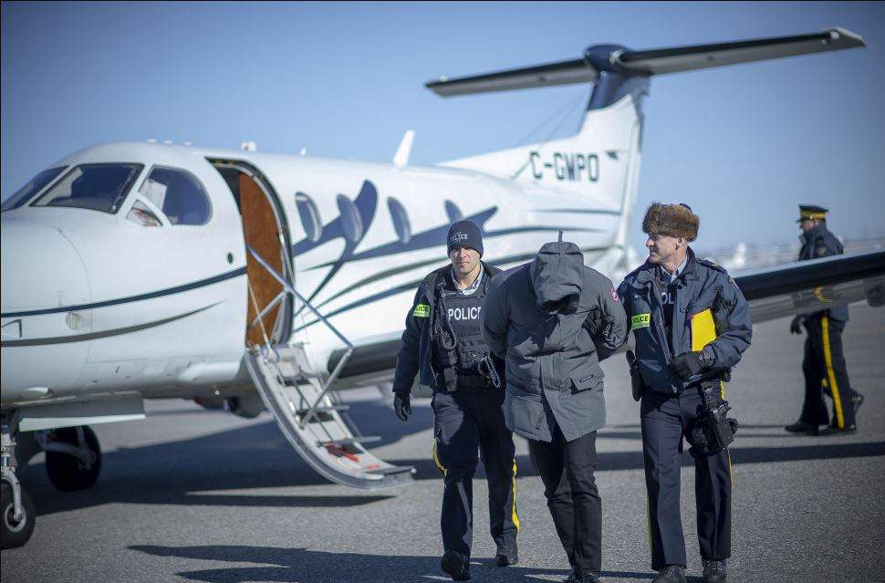 In this undated RCMP handout an individual is arrested as part of a money laundering investigation.