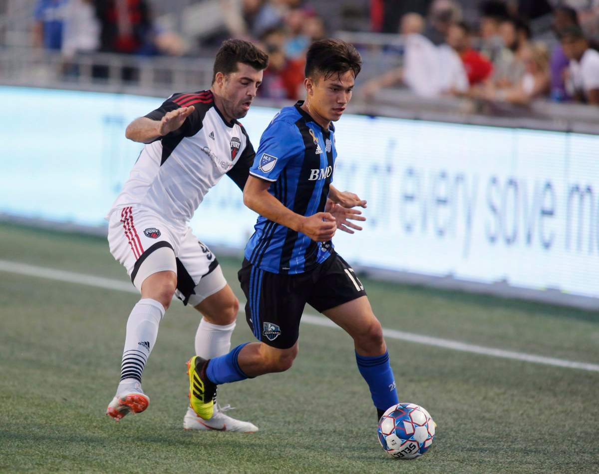 Montreal Impact Ken Krolicki (13) tries to keep the ball from Ottawa Fury FC Thiago de Freitas (93) during first half exhibition game soccer action in Ottawa on Friday, September 7, 2018.