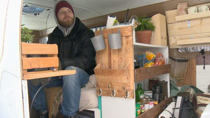 Jesse Boldt sits in his converted Dodge cargo van.