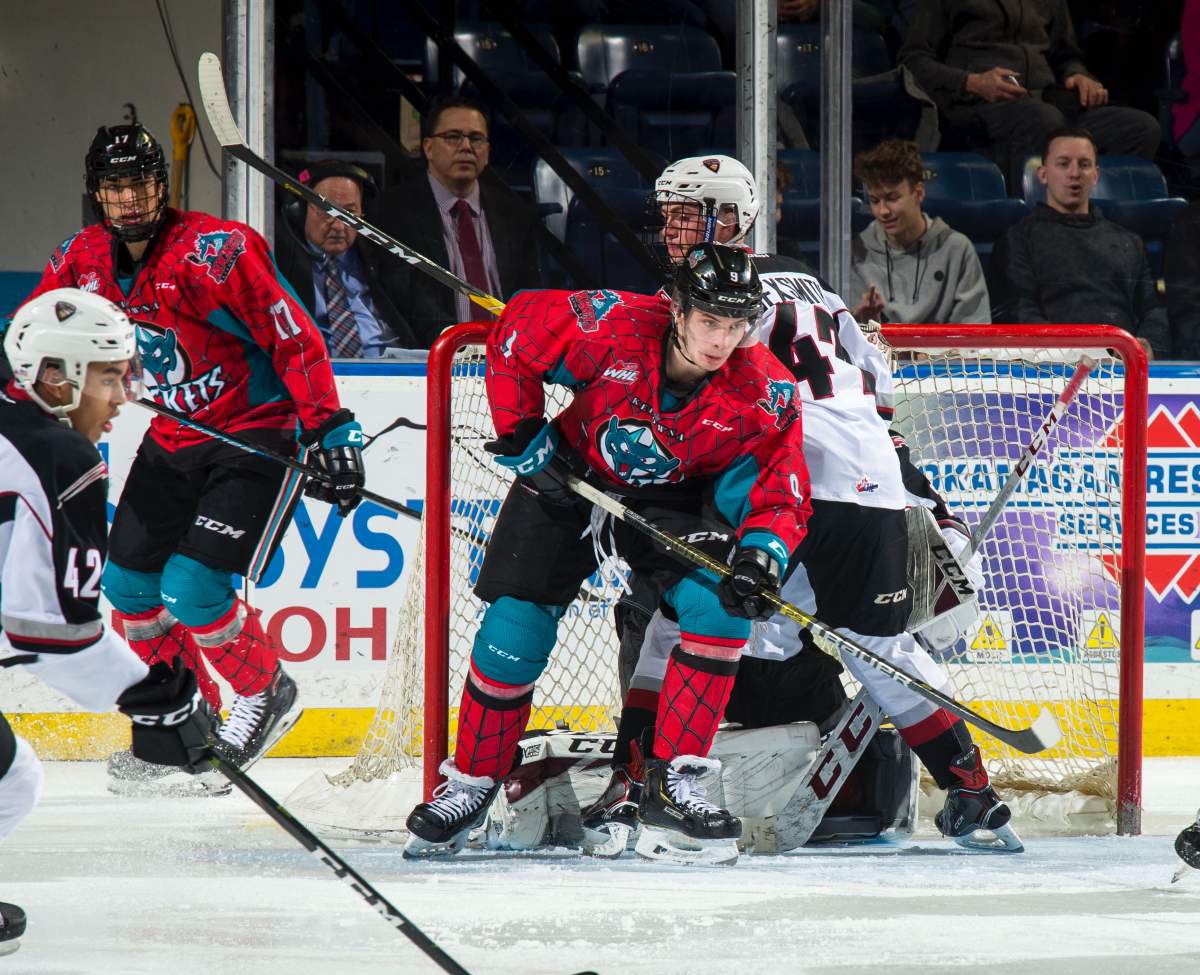 Mark Liwiski #9 of the Kelowna Rockets is checked by Joel Sexsmith #47 of the Vancouver Giants during third period on March 16, 2019 at Prospera Place in Kelowna, British Columbia, Canada. 
