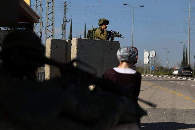 An Israeli soldier guards near the scene of Sunday's attack near the Jewish settlement of Ariel, in the Israeli-occupied West Bank March 18, 2019. 