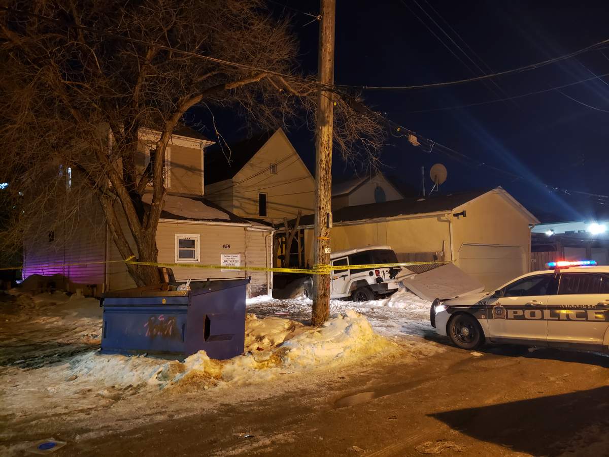The back alley behind Langside Street near Ellice Avenue was closed off Sunday night.