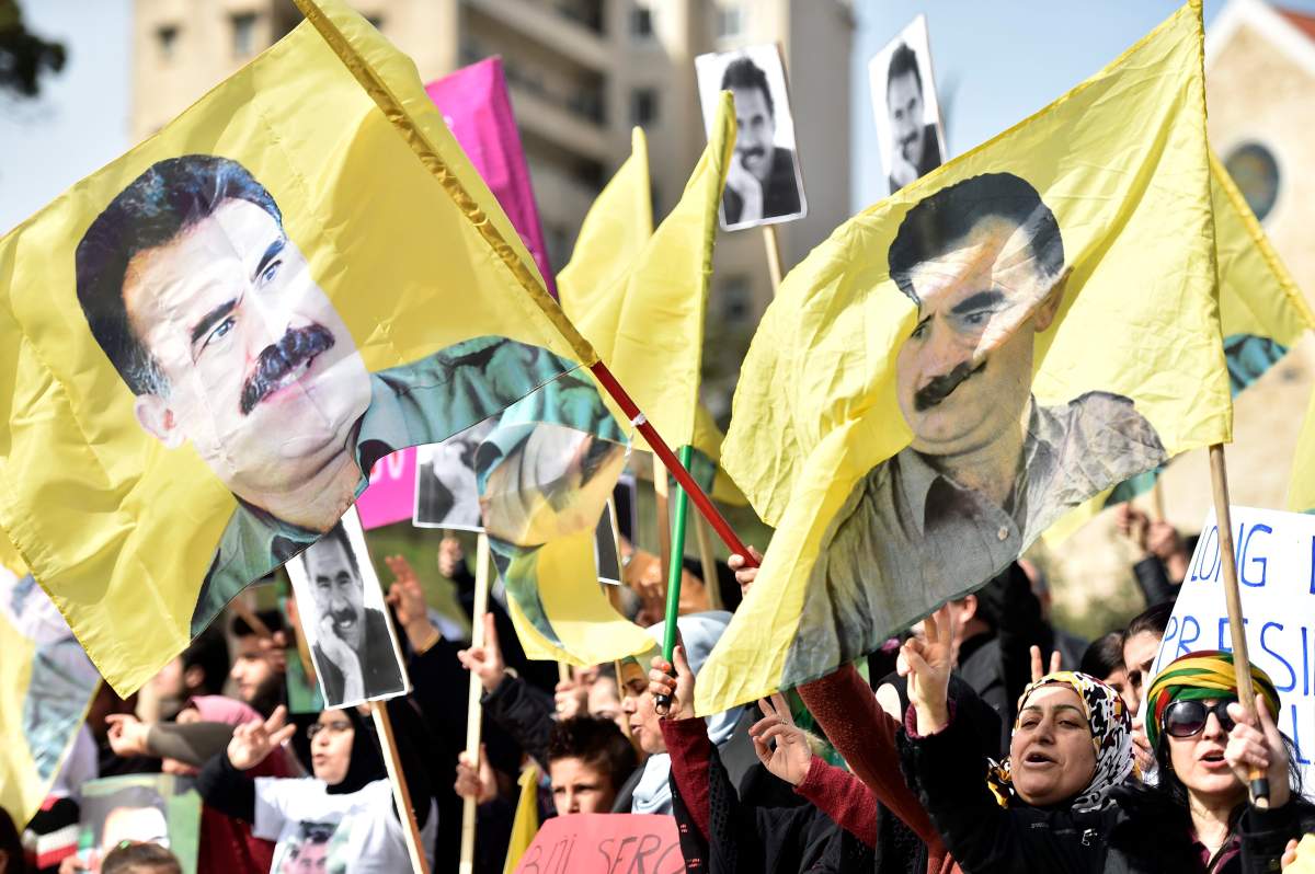 Supporters of Kurdistan Workers’ Party (PKK) carry flags bearing the image of (PKK) leader Abdullah Ocalan during a protest in Beirut, Feb. 15, 2019. EPA/WAEL HAMZEH