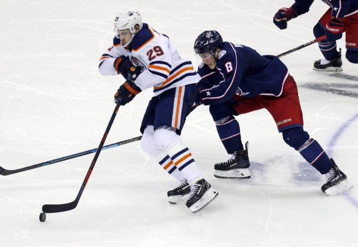 Edmonton Oilers forward Leon Draisaitl, left, of Germany, controls the puck against Columbus Blue Jackets defenseman Zach Werenski during the third period of an NHL hockey game in Columbus, Ohio, on Saturday, March 2, 2019. The Oilers won 4-0.