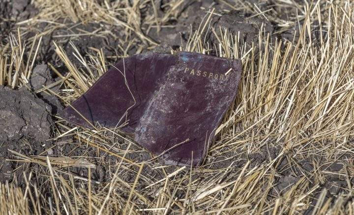 A passenger passport lies on the ground at the scene of an Ethiopian Airlines flight crash near Bishoftu, or Debre Zeit, south of Addis Ababa, Ethiopia, Monday, March 11, 2019.
