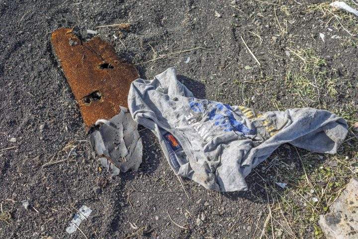 Clothing lies on the ground at the crash scene of an Ethiopian Airlines flight crash near Bishoftu, or Debre Zeit, south of Addis Ababa, Ethiopia, Monday, March 11, 2019.