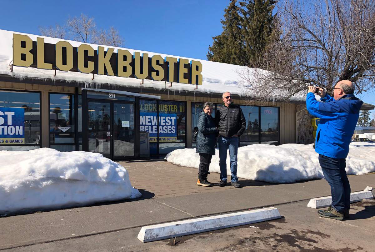 Debby Saltzman, of Bend, Ore., poses for a photo on Monday, March 11, 2019, in front of the last Blockbuster store on the planet with her twin brother, Michael Trovato. Trovato was visiting from Melbourne, Australia, where he lives. Taking the photo is Saltzman’s husband, Jeremy Saltzman.