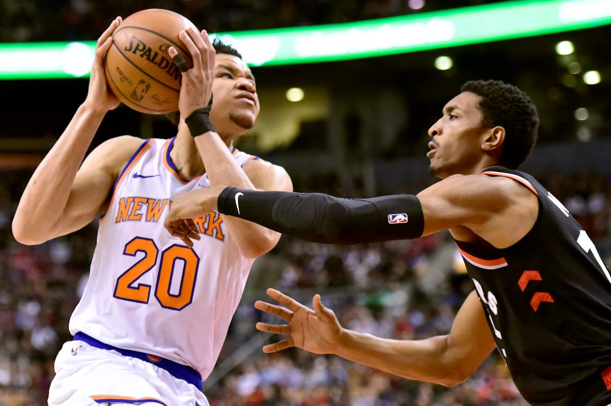 New York Knicks forward Kevin Knox (20) drives to the net as Toronto Raptors forward Malcolm Miller (13) defends during second half NBA basketball action in Toronto, Monday, March 18, 2019. THE CANADIAN PRESS/Frank Gunn