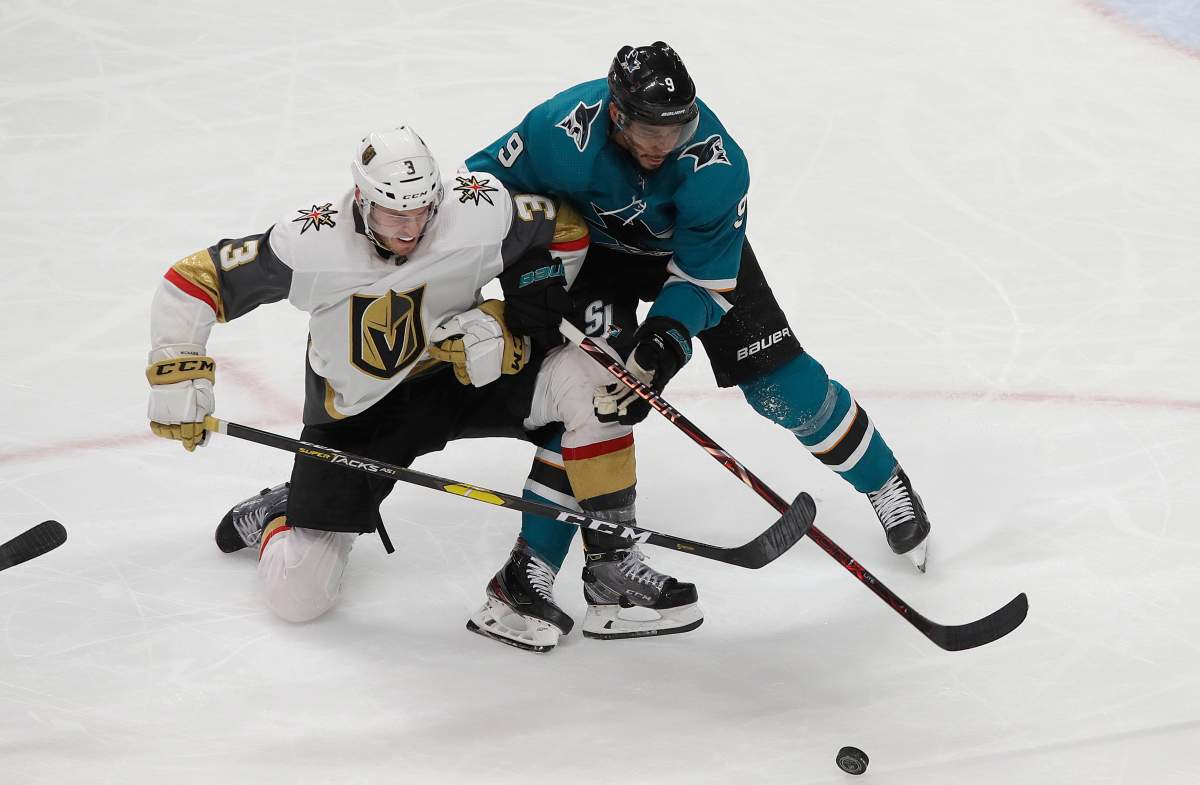 San Jose Sharks left wing Evander Kane, right, reaches for the puck next to Vegas Golden Knights defenseman Brayden McNabb during the third period of an NHL hockey game in San Jose, Calif., Monday, March 18, 2019. (AP Photo/Jeff Chiu)