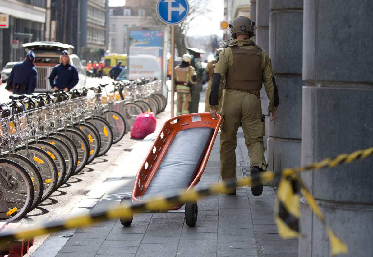 A member of emergency personnel carries a stretcher down a street in the EU quarter of Brussels, during a bomb alert.