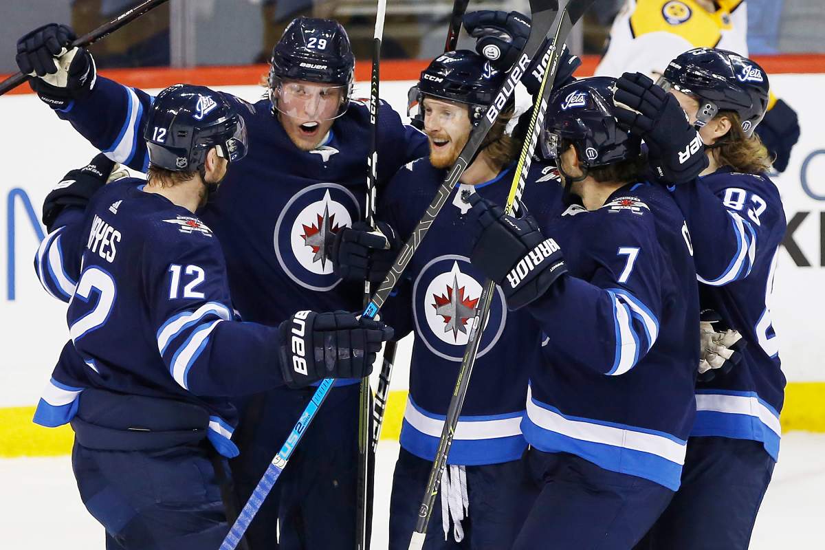 Winnipeg Jets' Kevin Hayes (12), Patrik Laine (29), Kyle Connor (81), Ben Chiarot (7) and Sami Niku (83) celebrate Connor's second goal of the game during third period NHL action against the Nashville Predators, in Winnipeg on Saturday, March 23, 2019. THE CANADIAN PRESS/John Woods.