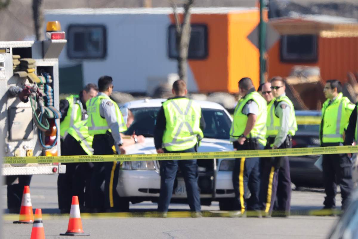 Burnaby RCMP at the scene of a hit and run on Monday that left two officers critically injured.
