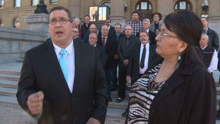 Dave Bjorkman (front left), Virginia Bruneau (front right) and other members of the Alberta Independence Party are pictured at a media event outside the Alberta legislature on March 20, 2019.