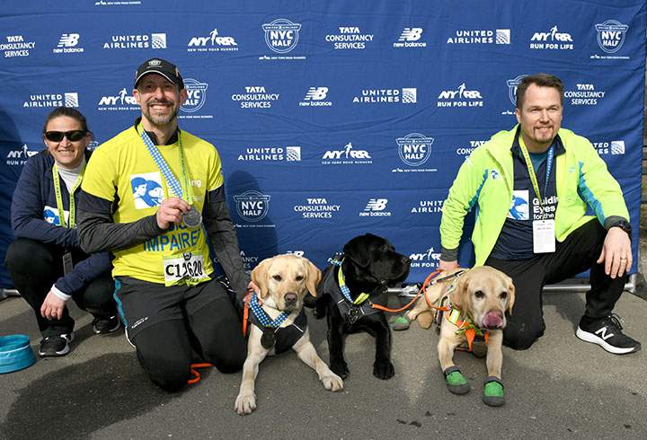 Guiding Eyes for the Blind President and CEO, Thomas Panek, runs the first ever 2019 United Airlines NYC Half Marathon led completely by guide dogs, Waffle, Westley and Gus on March 17, 2019 in New York City.
