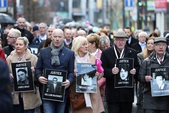 Families hold photographs of the victims of Bloody Sunday and march through the Bogside in Londonderry, Northern Ireland, Thursday March 14, 2019.