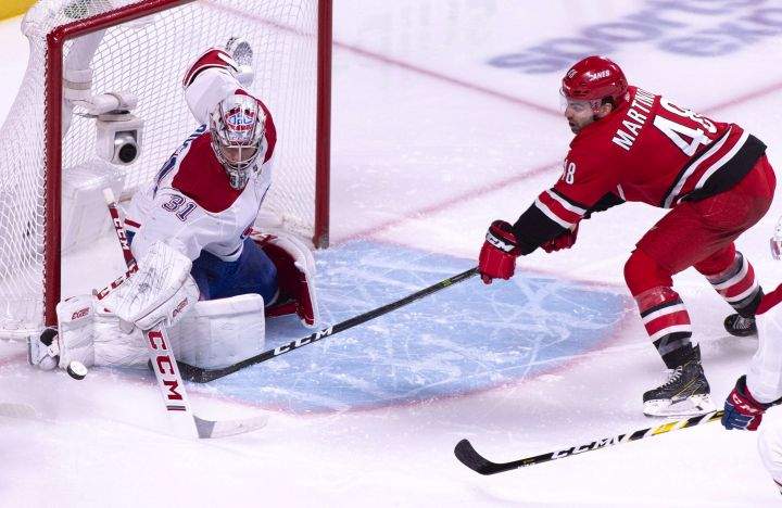 Montreal Canadiens goaltender Carey Price stops Carolina Hurricanes' Jordan Martinook during second period NHL hockey action in Montreal on Thursday, December 13, 2018. 