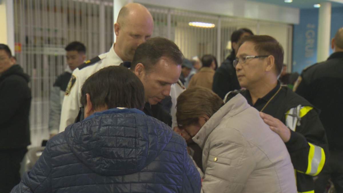 Winnipeg police chief Danny Smyth consoles Imelda Adao, who lost her son in a random home invasion.