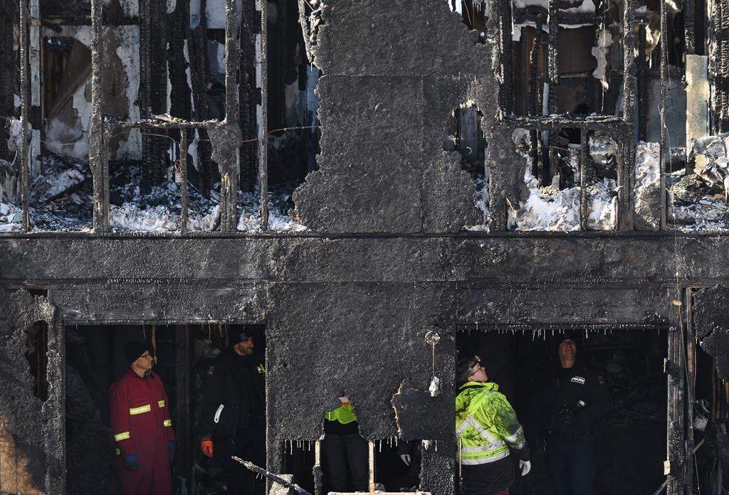 Police and firefighters investigate at the scene of a fatal house fire in the Spryfield community in Halifax on Tuesday, February 19, 2019.
