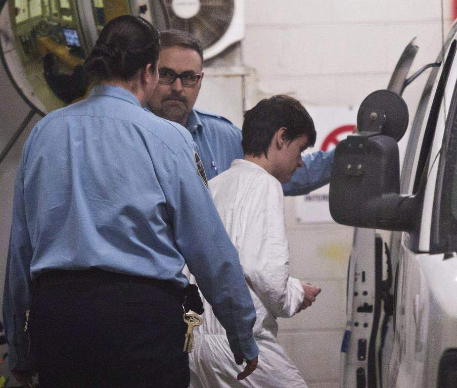 Alexandre Bissonnette is escorted to a van after appearing in court for the deadly shooting at a mosque, Monday, January 30, 2017 in Quebec City. 