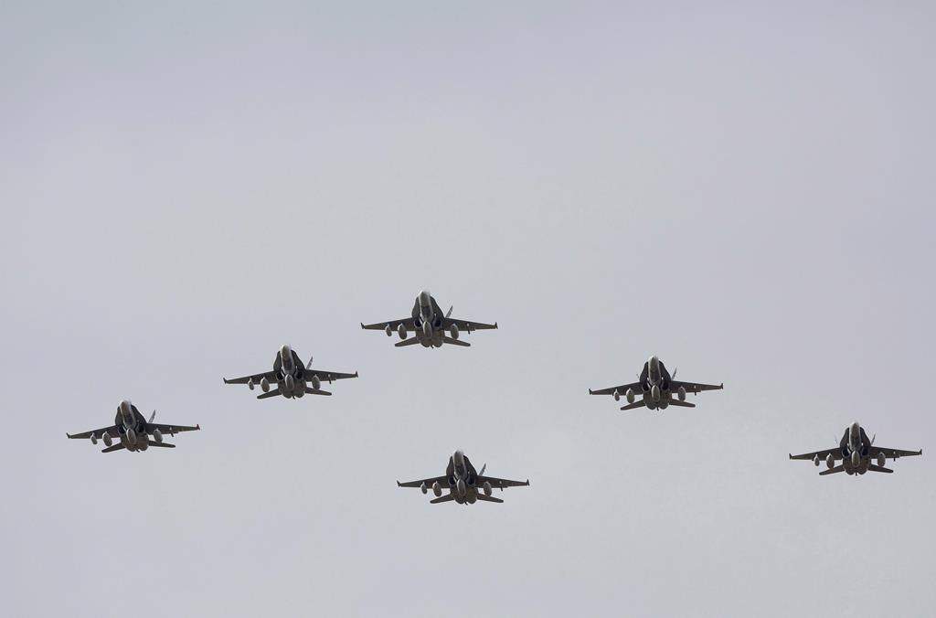 CF-18 Hornets fly in formation on their the departure for Operation IMPACT, in Cold Lake, Alberta on Tuesday October 21, 2014. THE CANADIAN PRESS/Jason Franson.