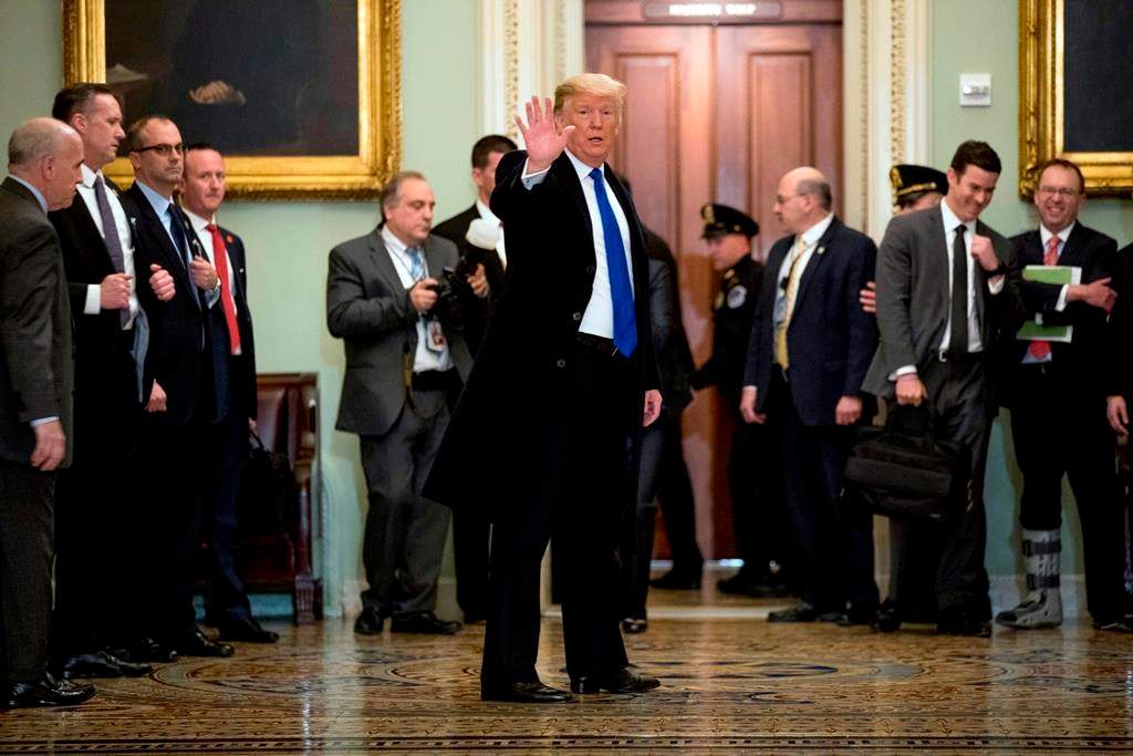 President Donald Trump speaks to members of the media as he departs a Senate Republican policy lunch on Capitol Hill in Washington, Tuesday, March 26, 2019.