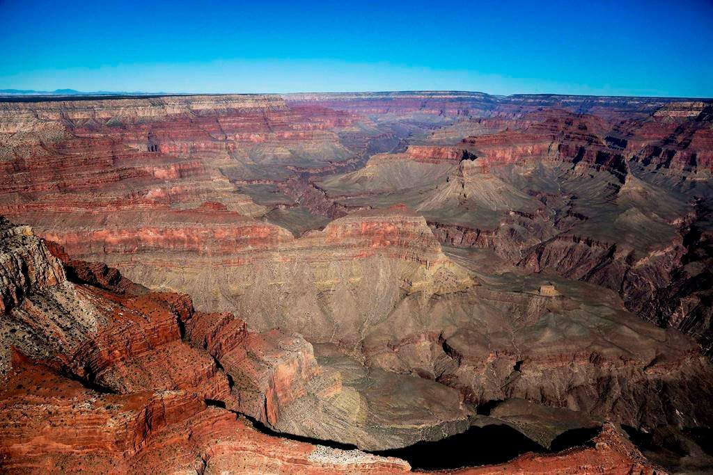 In this Oct. 5, 2013 file photo, the Grand Canyon National Park is covered in the morning sunlight as seen from a helicopter near Tusayan, Ariz.